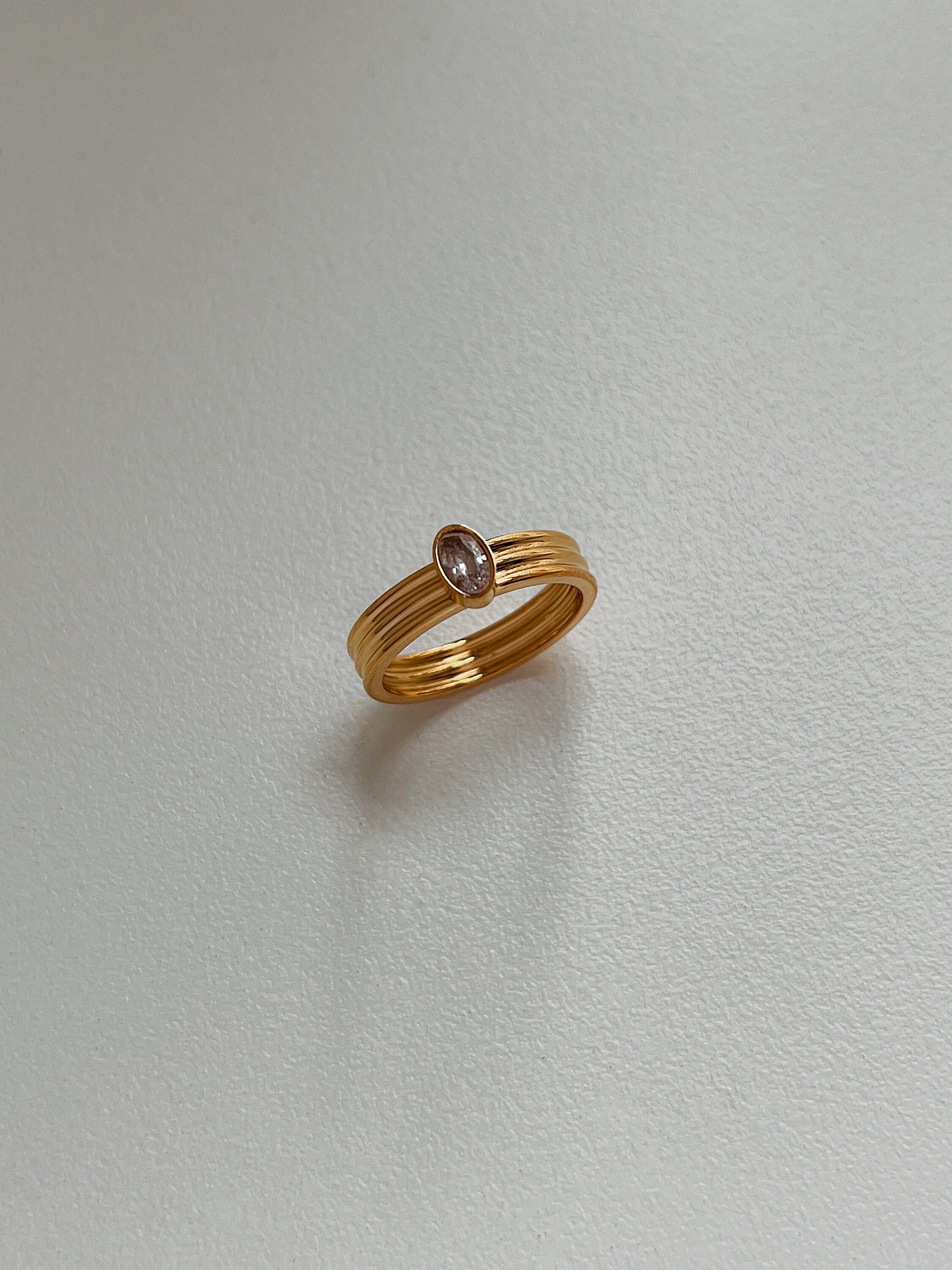 Gold ribbed statement band with 5A grade cubic zirconia oval stone