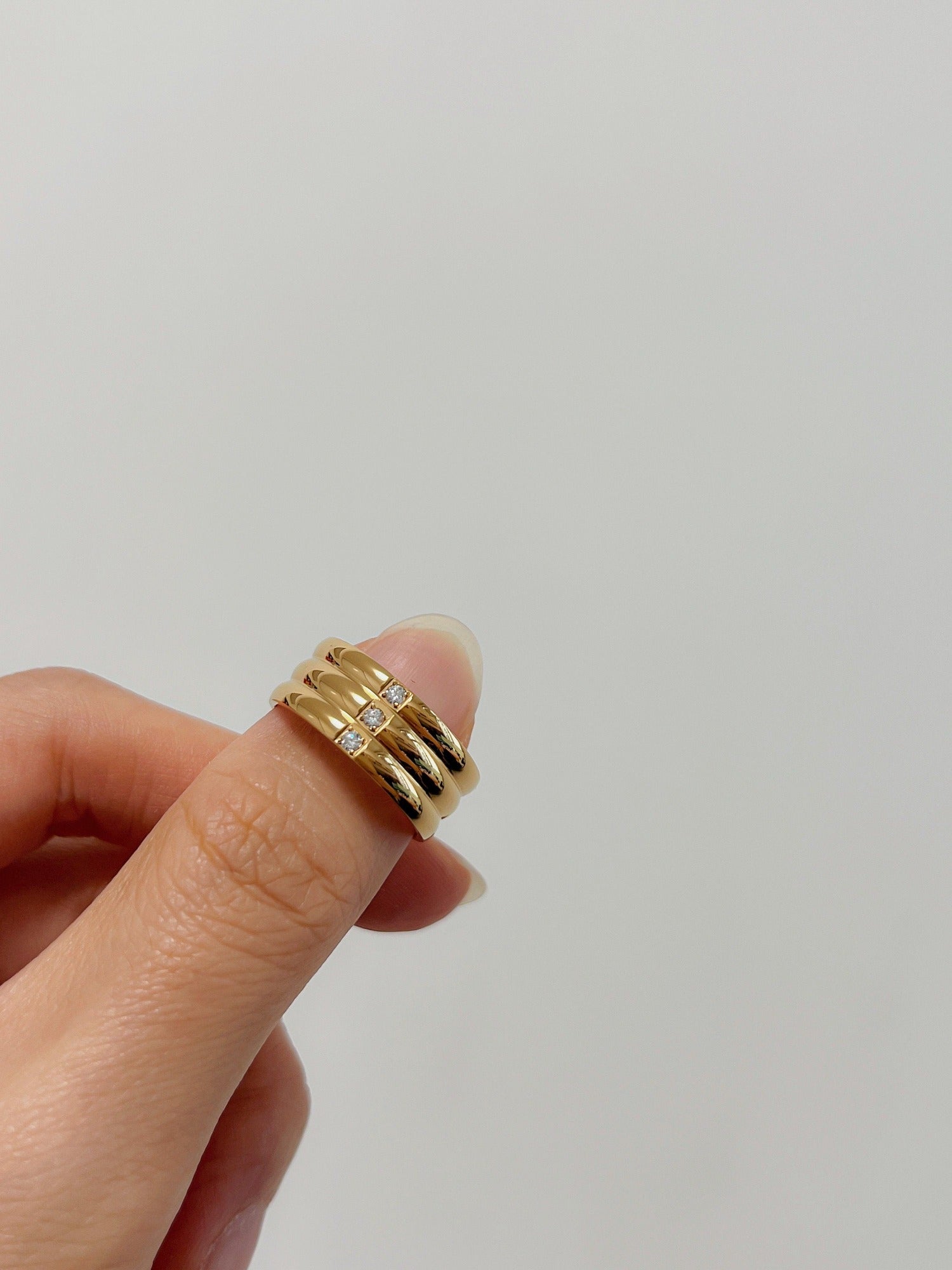 Triple stacked ribbed gold ring with three 5A cubic zirconia stones