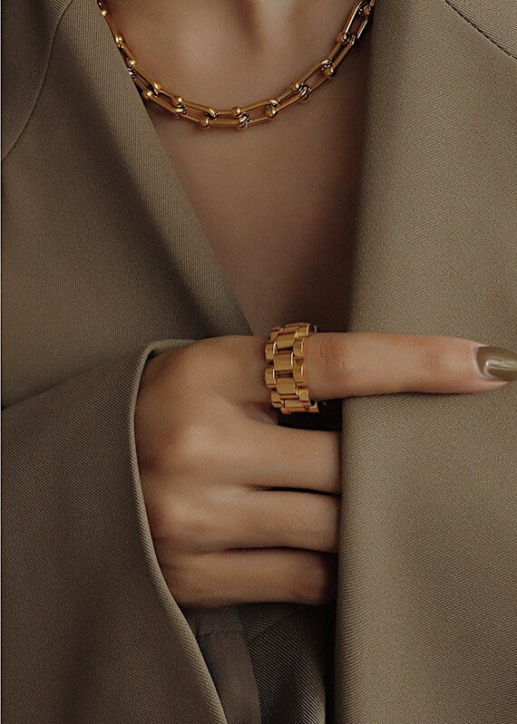 Close up of half body styling gold jewellery for high-end UK fashion