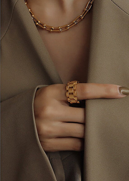 Close up of half body styling gold jewellery for high-end UK fashion
