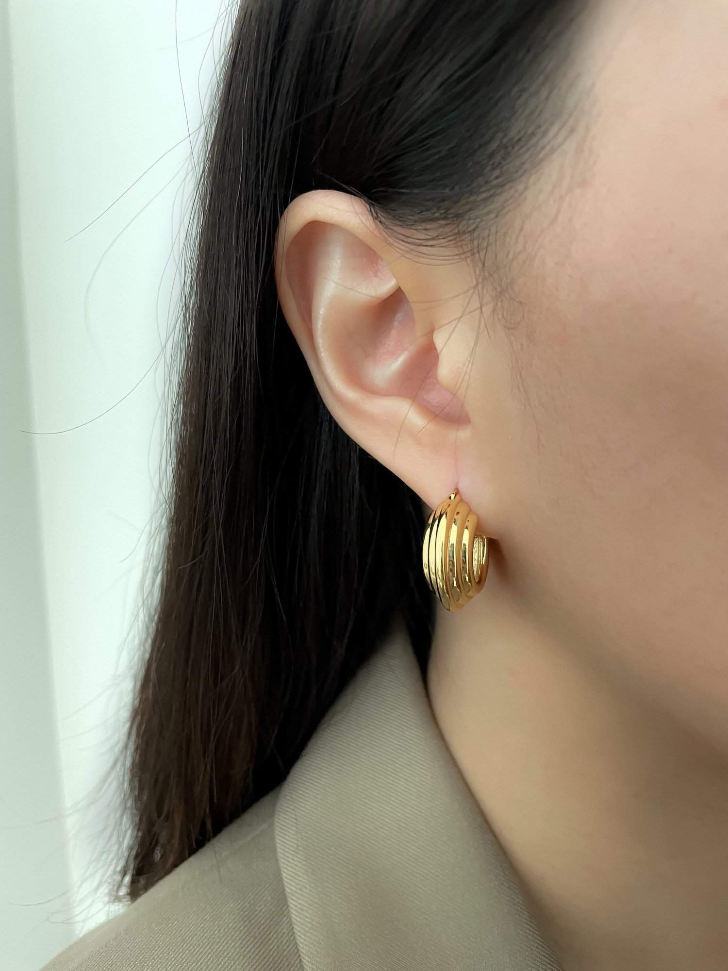 Beautiful gold hoop earrings on model, must-have jewelry for fashion enthusiasts