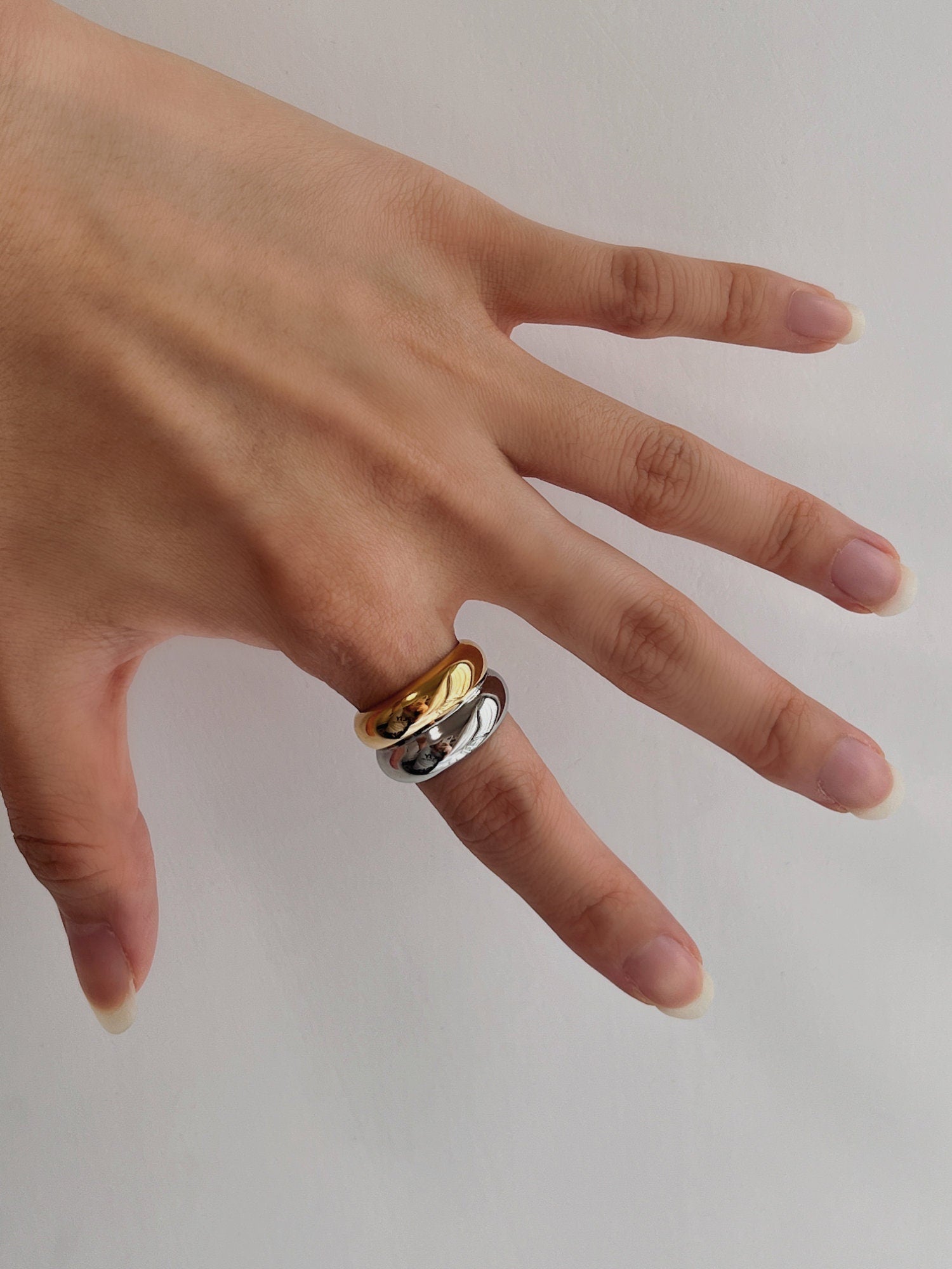 Professional hand jewelry shot featuring the chunky two tone band in sunlight