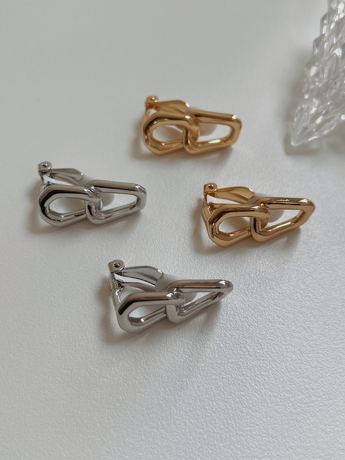 Macro detail showing the crisp beveled edges and luminous surface polish of interlocking gold jeweler's brass links.
