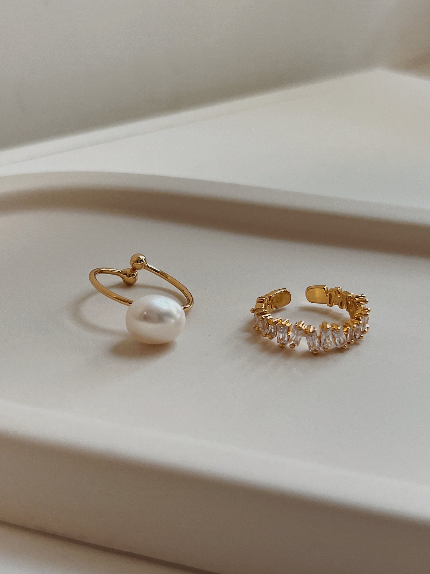 Close up of natural baroque pearl showing unique organic shape and baguette cz ring shows the brilliance of the band