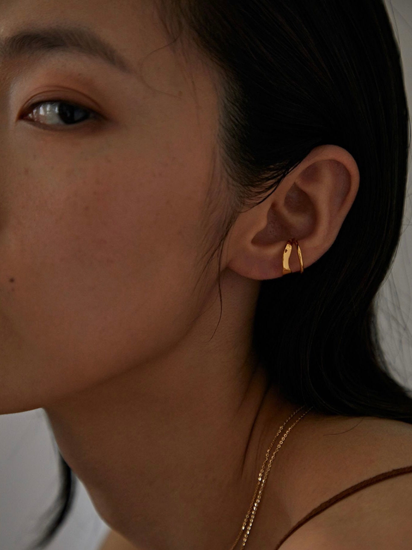 Fashion model wearing the Beverly cuff as a standalone architectural statement.