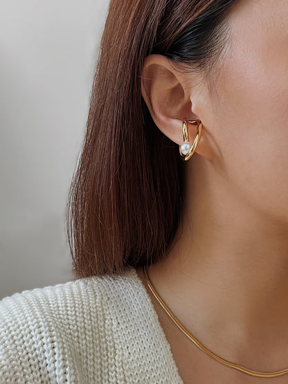 Close-up profile of model styling the Karolina Cuff on the earlobe
