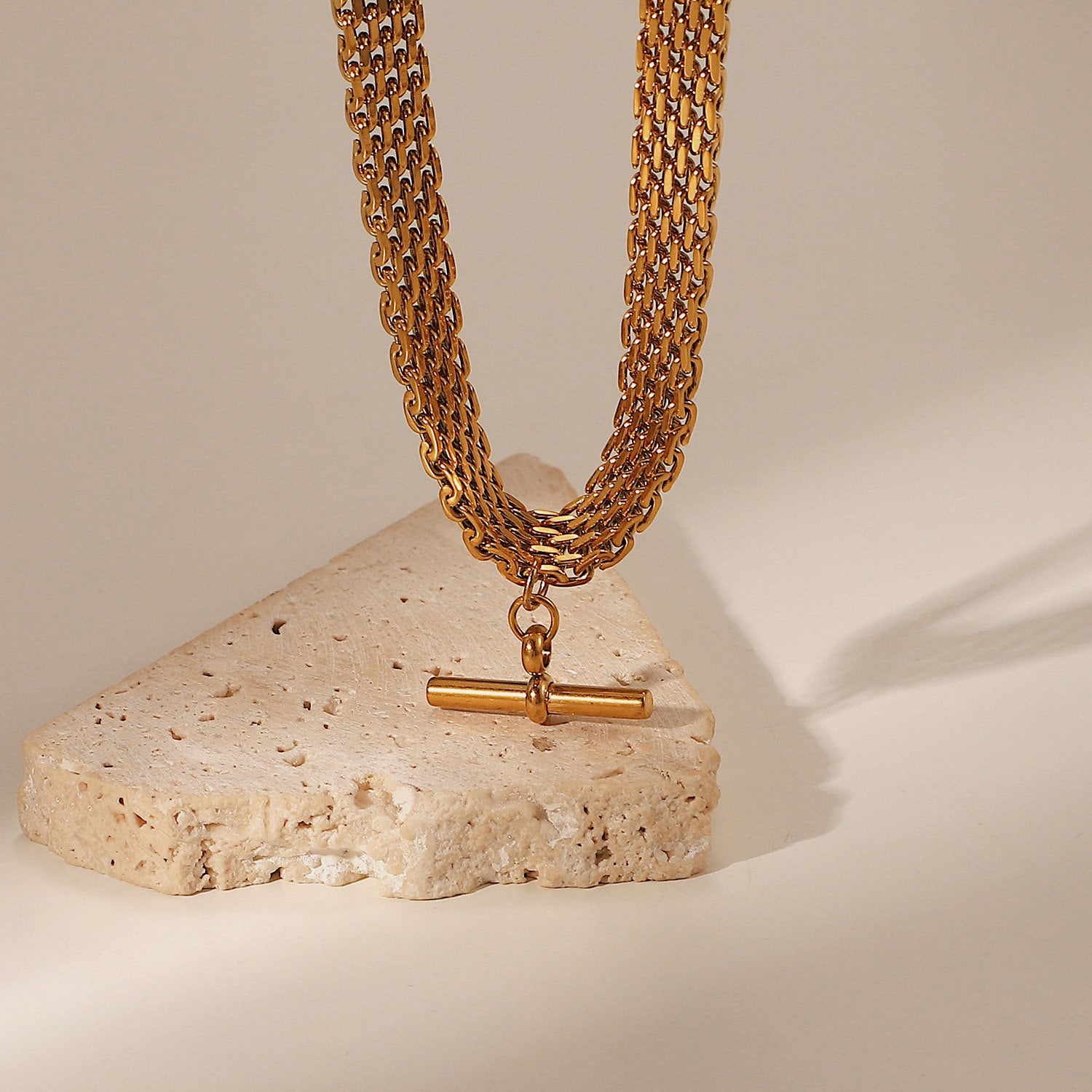 Sleek architectural hardware pendant collection displaying rich yellow gold luster variations