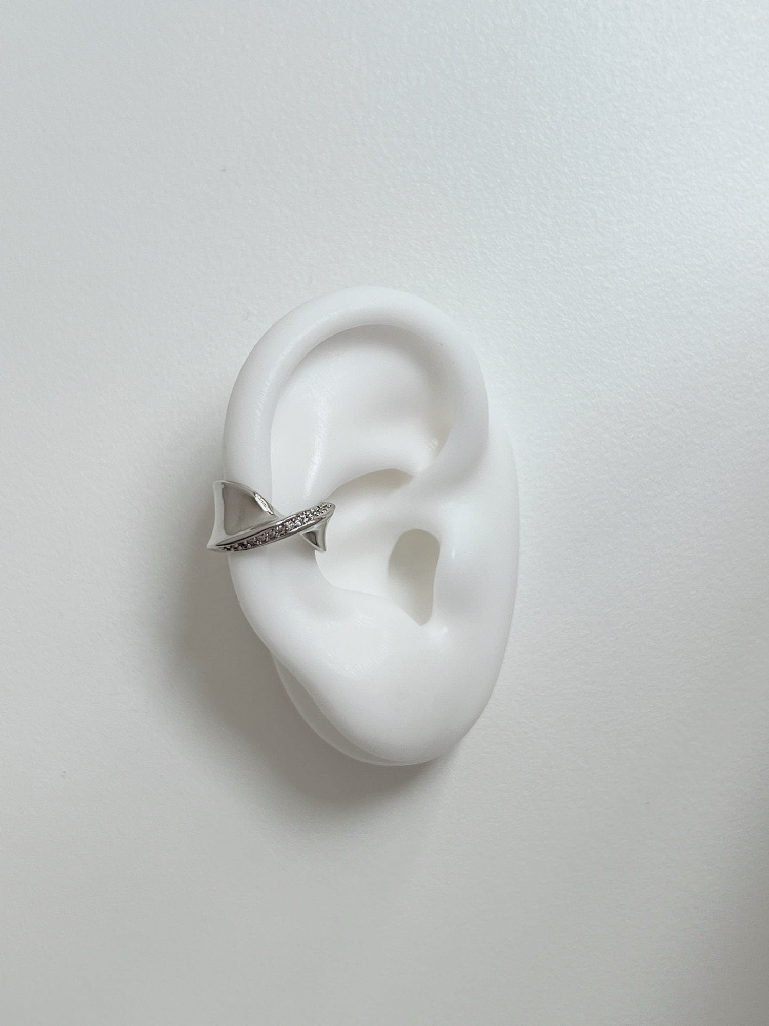 Close-up of Evelyn ear cuff in natural soft lighting.