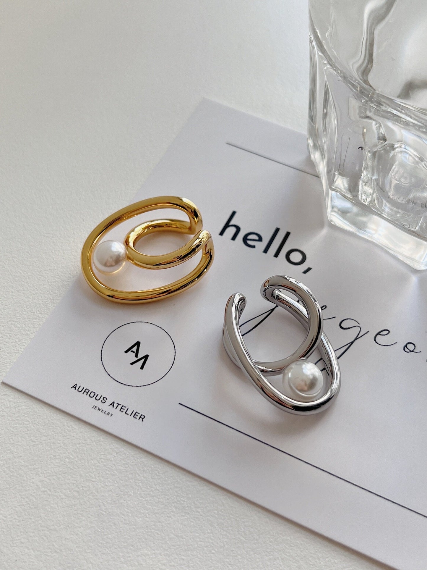 Gold and Silver Karolina Cuffs on an Aurous Atelier jewelry card
