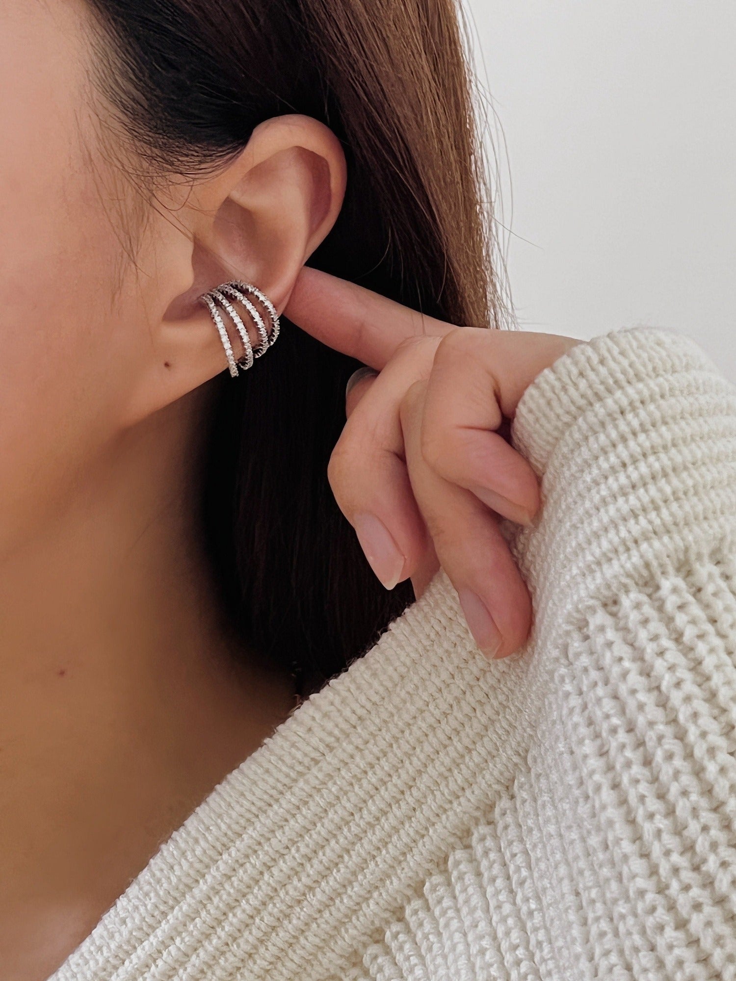 Model styling Aurelia pavé cuff with slicked-back hair.