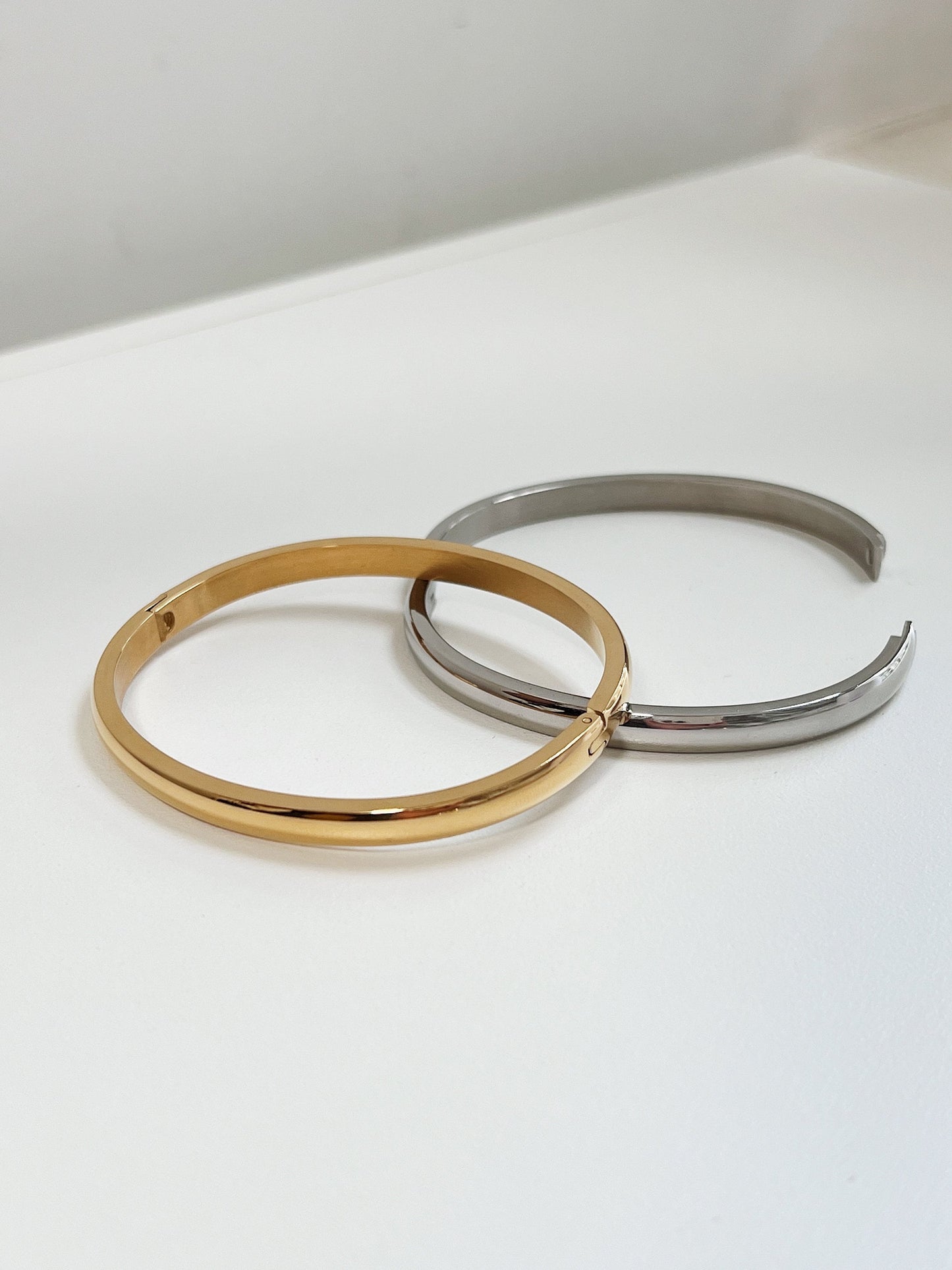 Side profile detail highlighting the 4mm curved surface and continuous mirror finish of the Jayden oval bangle.