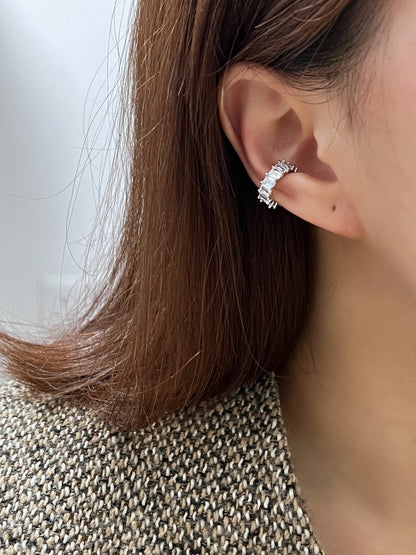Side profile of a model featuring a curated ear stack with waterproof silver cz ear cuff.