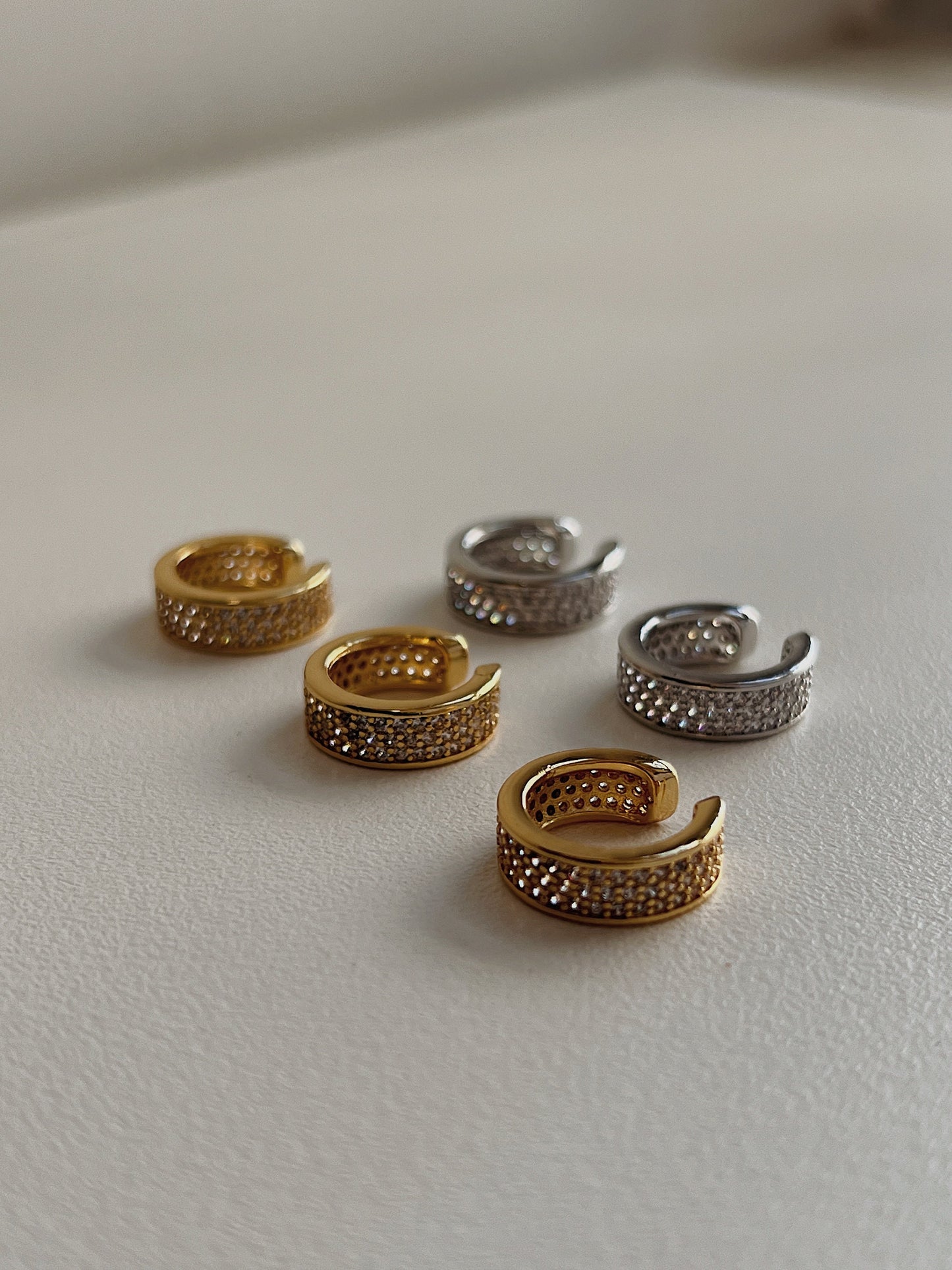 Close up of 14K gold plating and cubic zirconia texture on Priscilla cuff.