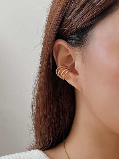 Close-up of ear stack styling with Aurelia gold cuff.