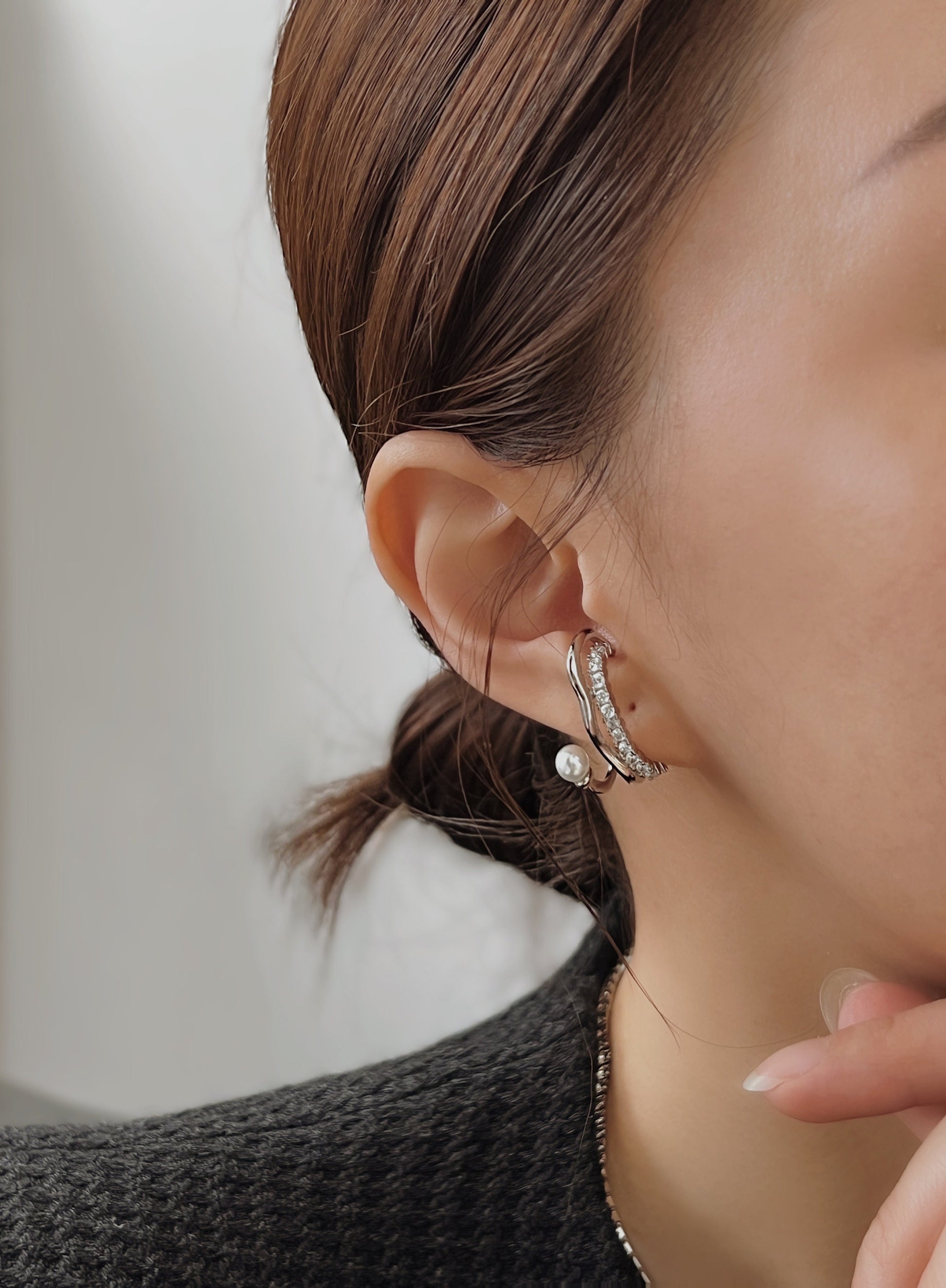 Model wearing Cassidy cuff, sophisticated pearl aesthetic.