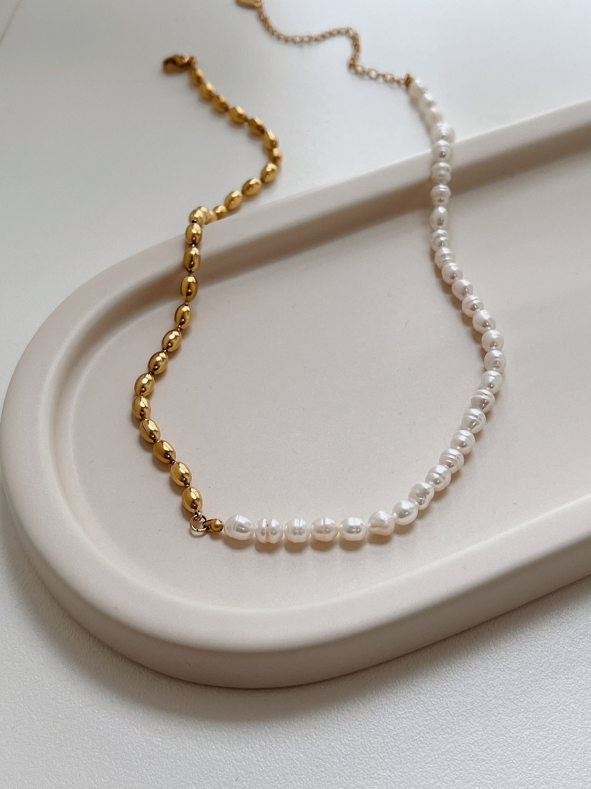 Colette half pearl half chain necklace layout displaying organic baroque pearls and gold beads