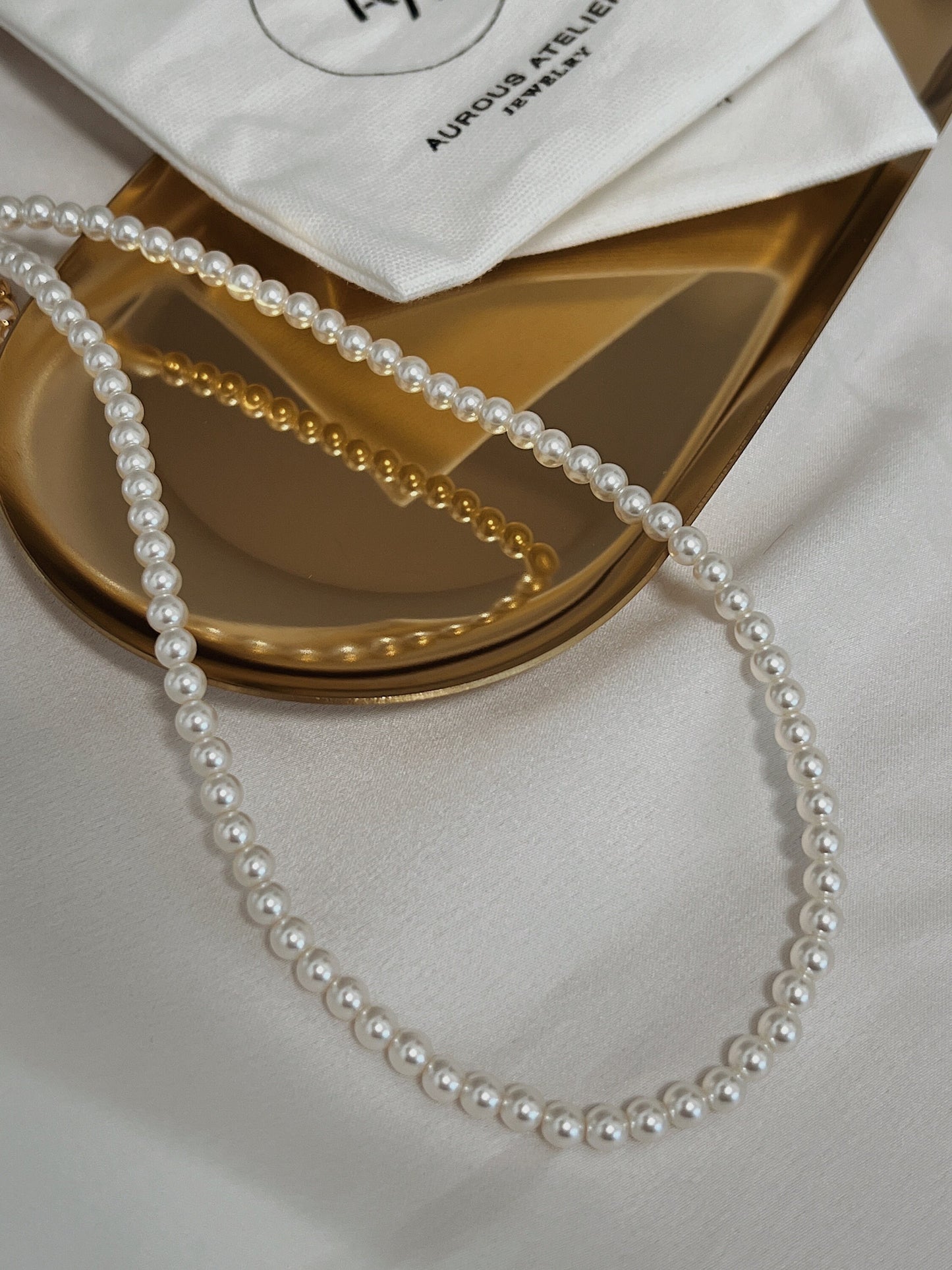 Front view of hypoallergenic solid brass core hardware fine pearl statement jewelry