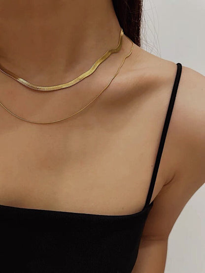 Woman neckline displaying the modern look of a pre stacked gold liquid metal ribbon close up