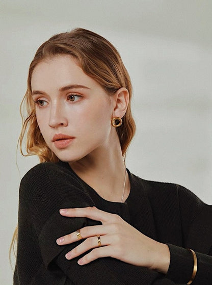 Editorial photography of gold ribbed rings and gold jewellery showcasing mirror luster