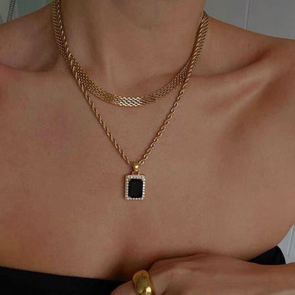 Girls outing fashion crop displaying a wide gold mesh choker with a black rectangle pendant necklace