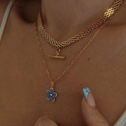 Close up of a professional woman wearing high shine abstract statement jewelry arrangements