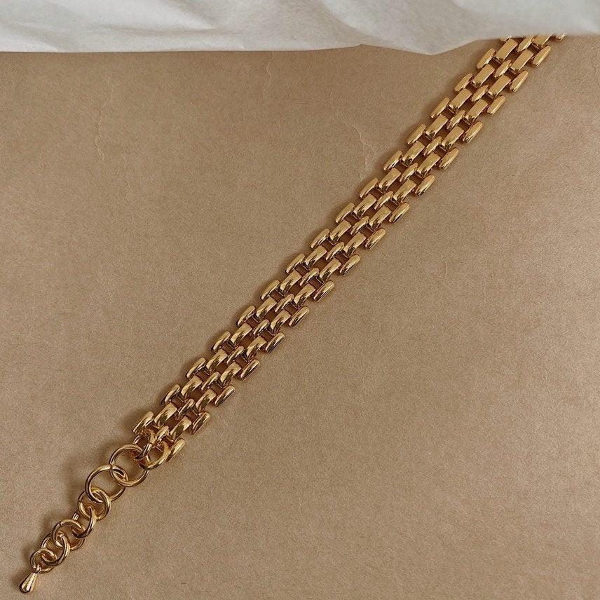 Elegant warm yellow gold bracelet showing the adjustable extension loops