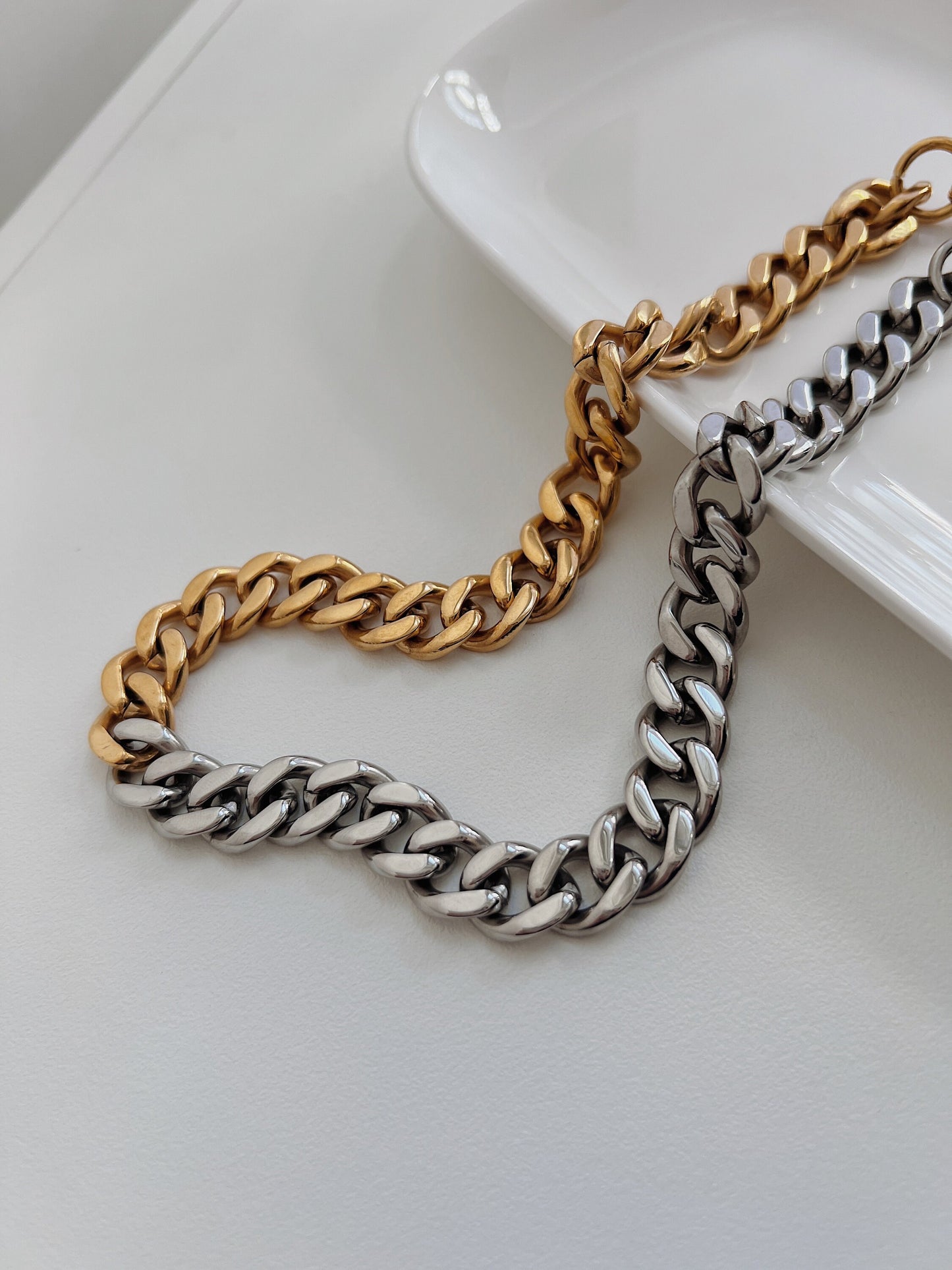 Durable sweat proof fashion jewellery wide cuban chain presented on minimalist editorial background