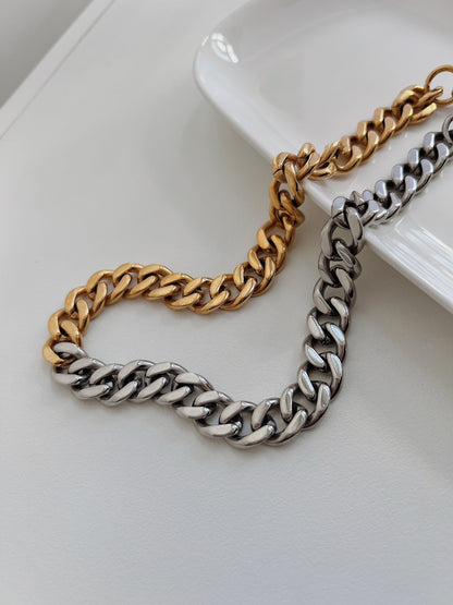 Durable sweat proof fashion jewellery wide cuban chain presented on minimalist editorial background