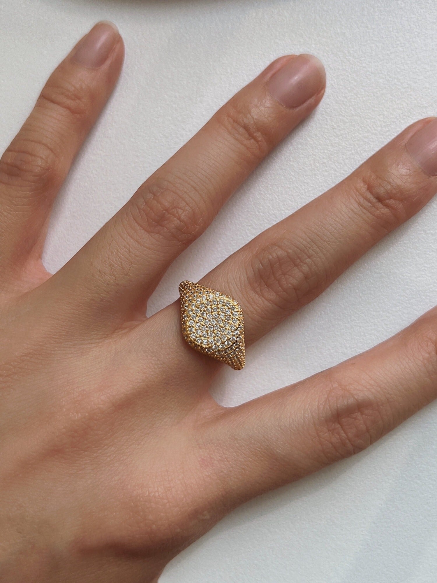 Elegant gold diamond signet ring on finger, luxury jewelry for women, sparkling design