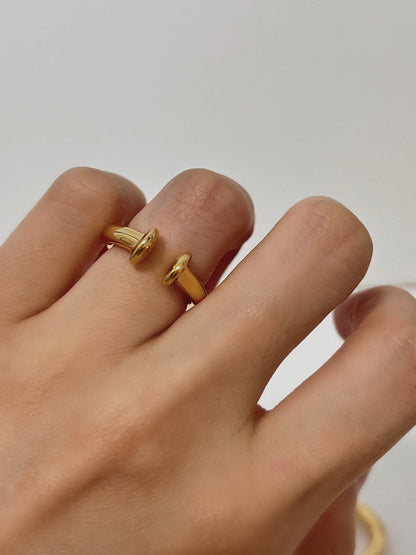 Close-up of gold ear cuff on finger, can be worn as a ring