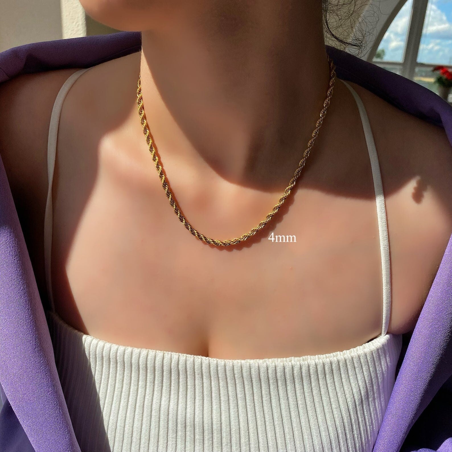 Model chest perspective illustrating how textured statement jewellery instantly elevates simple outfit