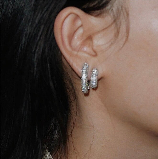 Model wearing both Jayne small and medium pavé clip-on hoop earrings close up shot