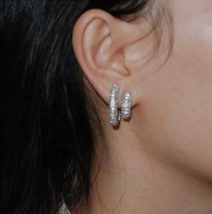 Model wearing both Jayne small and medium pavé clip-on hoop earrings close up shot