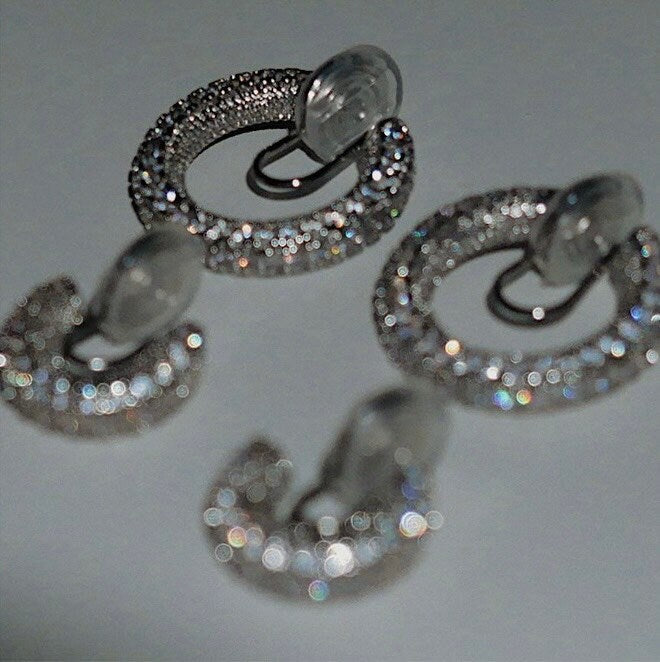 Macro detail of densely set 5A grade cubic zirconia stones on Jayne rhodium clip-on hoop earring