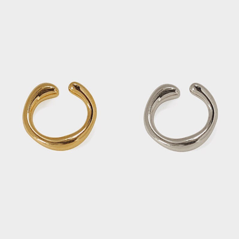 Studio shot of Leia Minimalist Ear Cuff in fluid 18k Gold and Rhodium Silver PVD