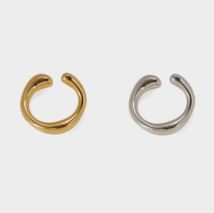 Studio shot of Leia Minimalist Ear Cuff in fluid 18k Gold and Rhodium Silver PVD