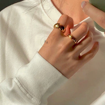 Active luxury styling of the Eloise gold ring on a hand model