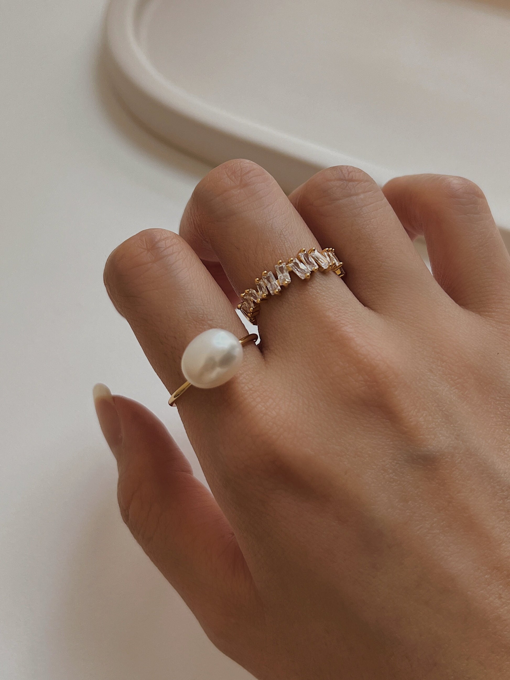 Lifestyle photography of pearl ring styled for coastal luxury