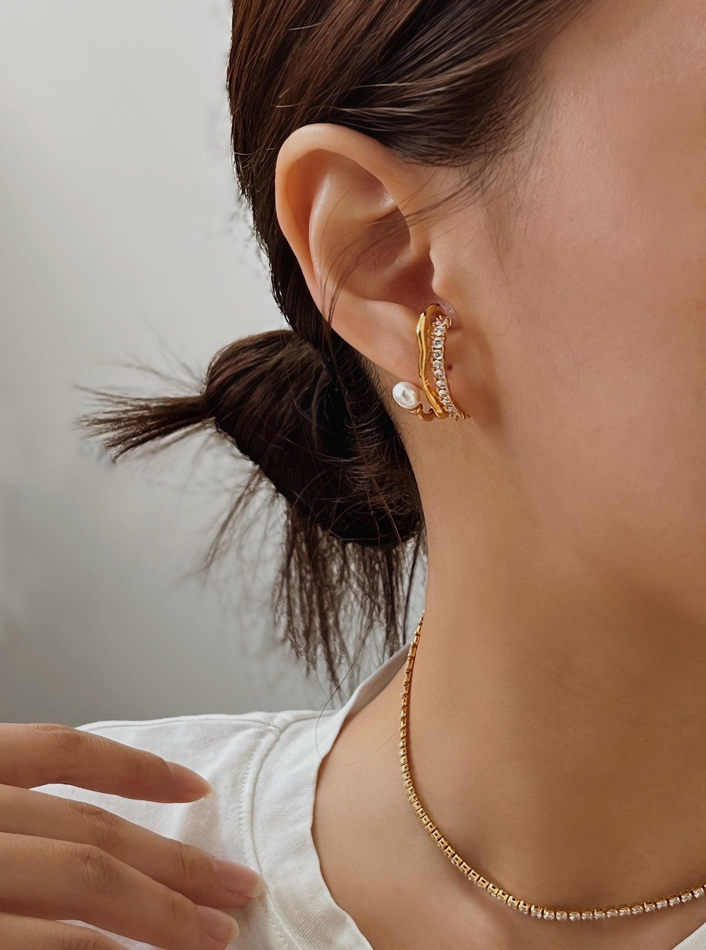Model showcasing Cassidy gold cuff with tennis necklace
