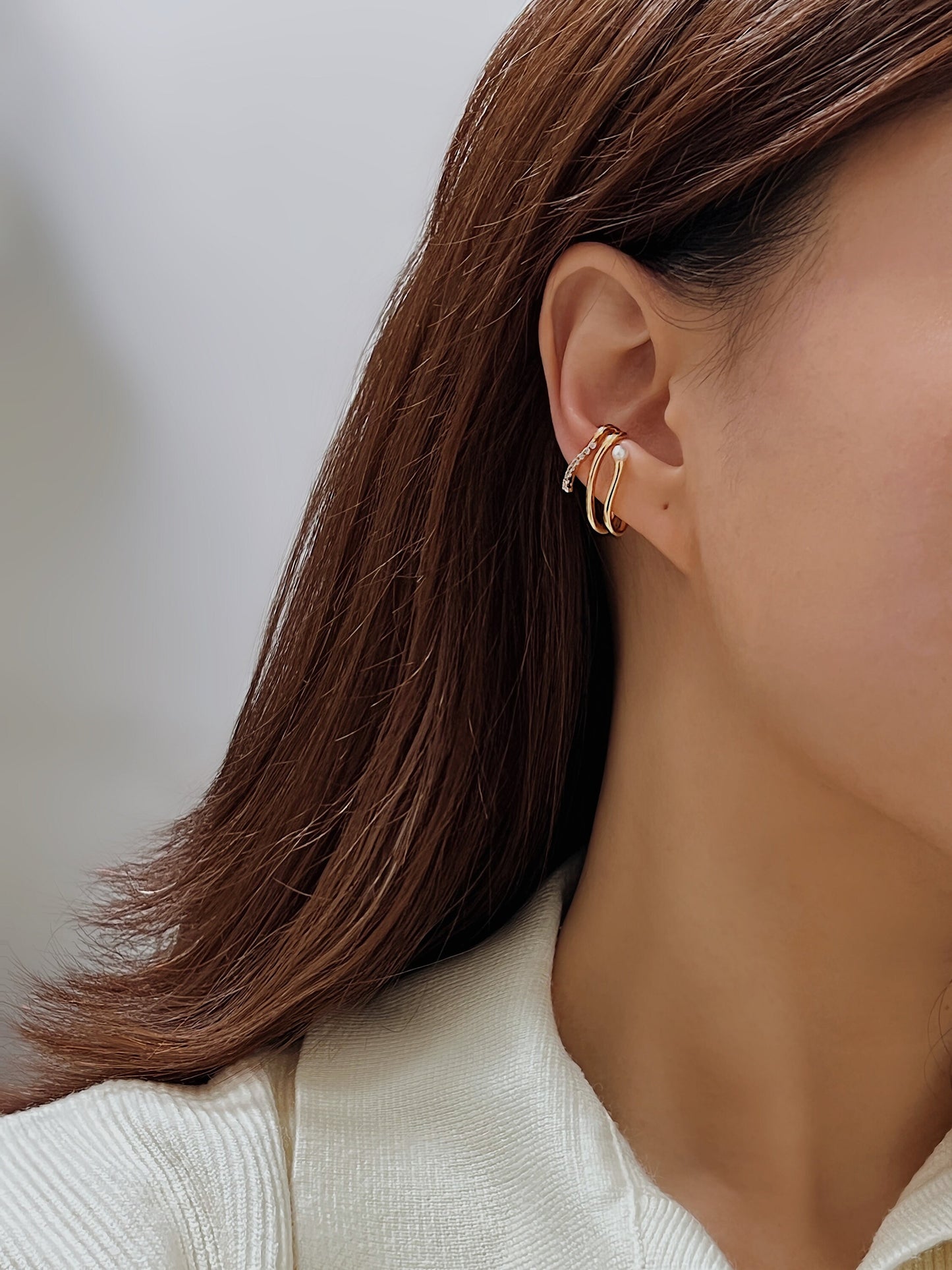 Model showcasing Heidi cuff with white sweater.
