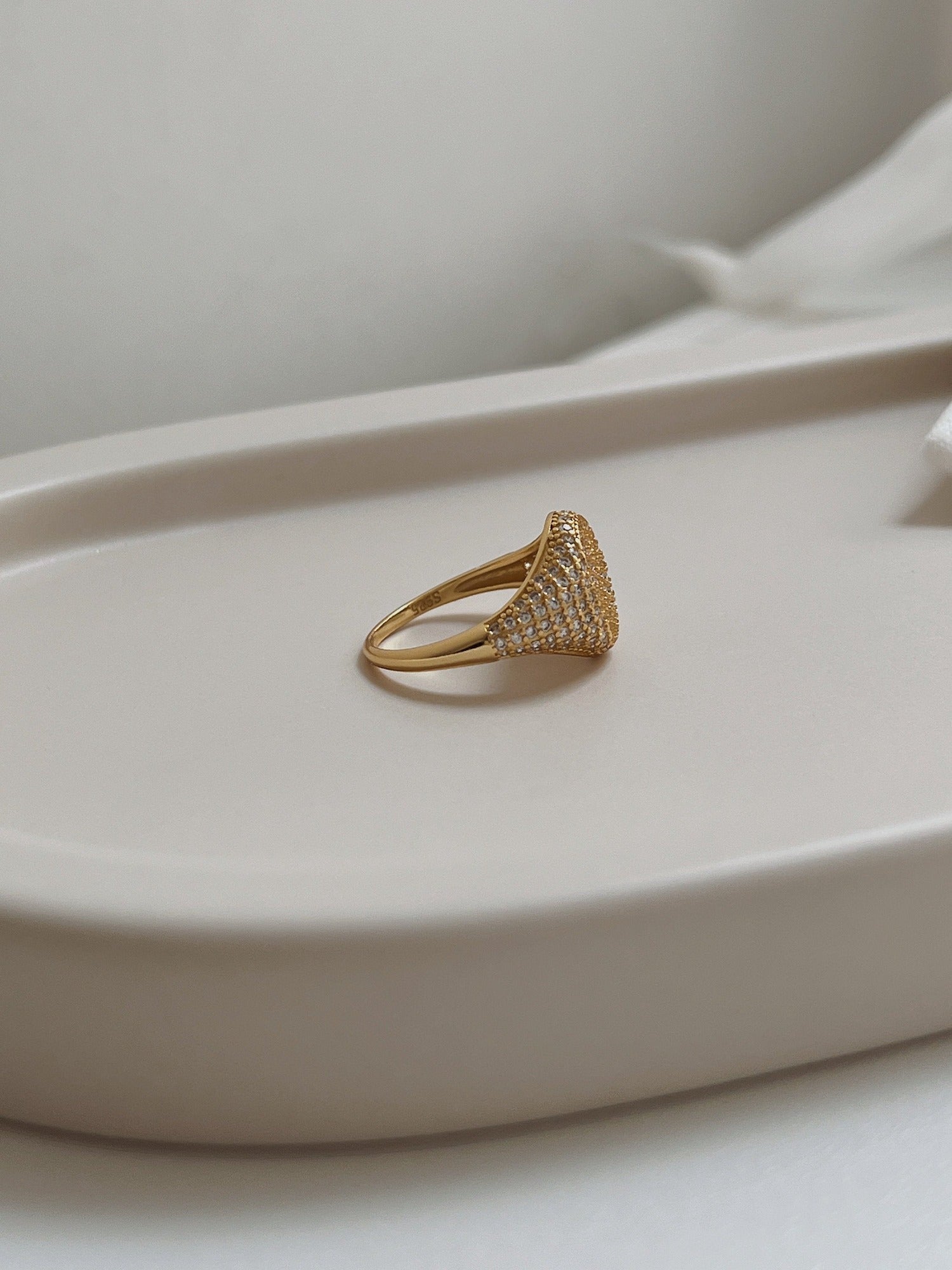 Side profile of sculptural 18k gold vermeil signet band.