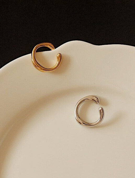 Organic fluid ear cuff design in 18k Gold and Rhodium PVD by Aurous Atelier