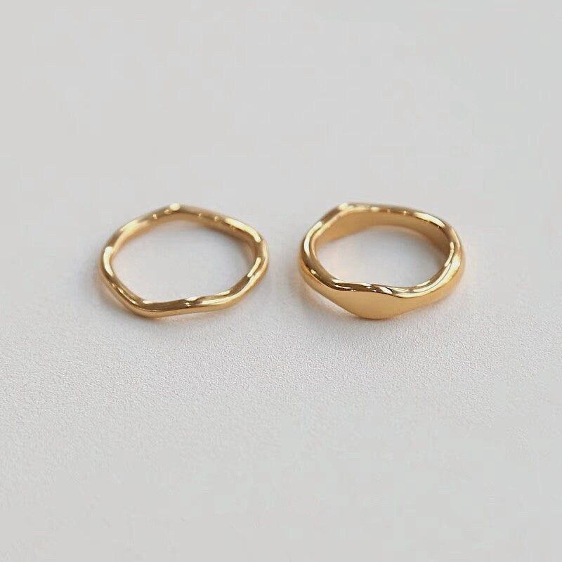 Modern luxe stackable wavy rings displayed on a clean background.