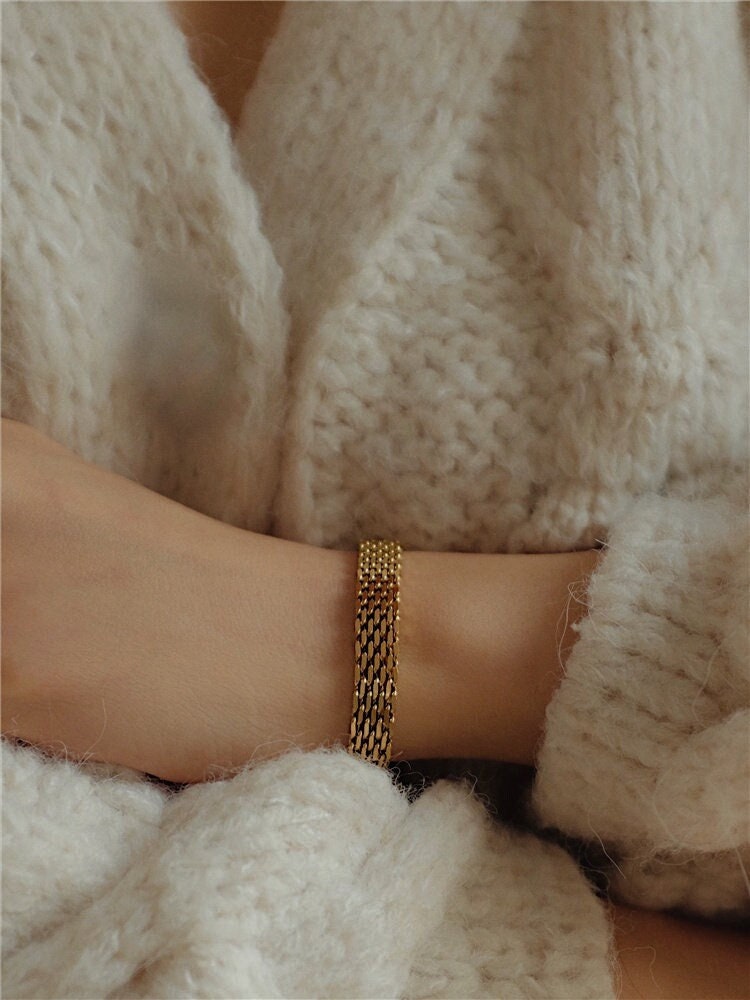 A clean side-angle profile view of the Danielle gold mesh chain bracelet framing a wrist, showcasing its low-profile fit and premium flexibility.