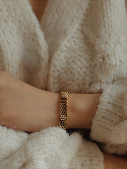 A clean side-angle profile view of the Danielle gold mesh chain bracelet framing a wrist, showcasing its low-profile fit and premium flexibility.