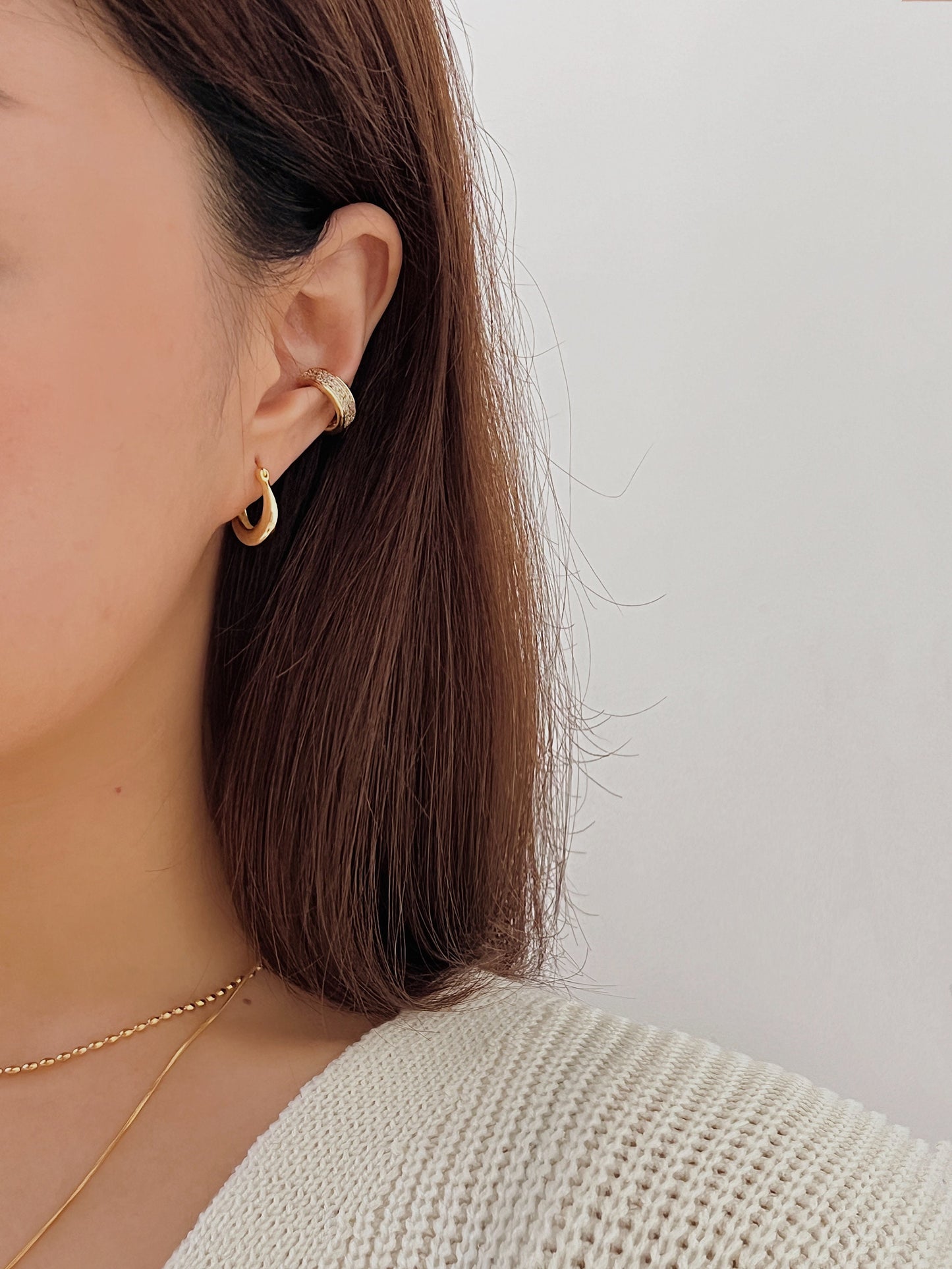 Multi-layered ear stack featuring Priscilla Thick Cuff in gold.