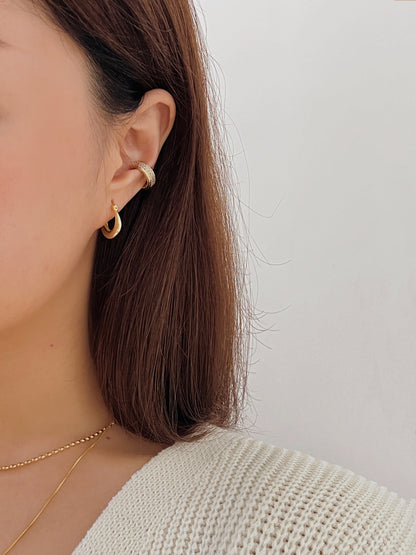 Multi-layered ear stack featuring Priscilla Thick Cuff in gold.