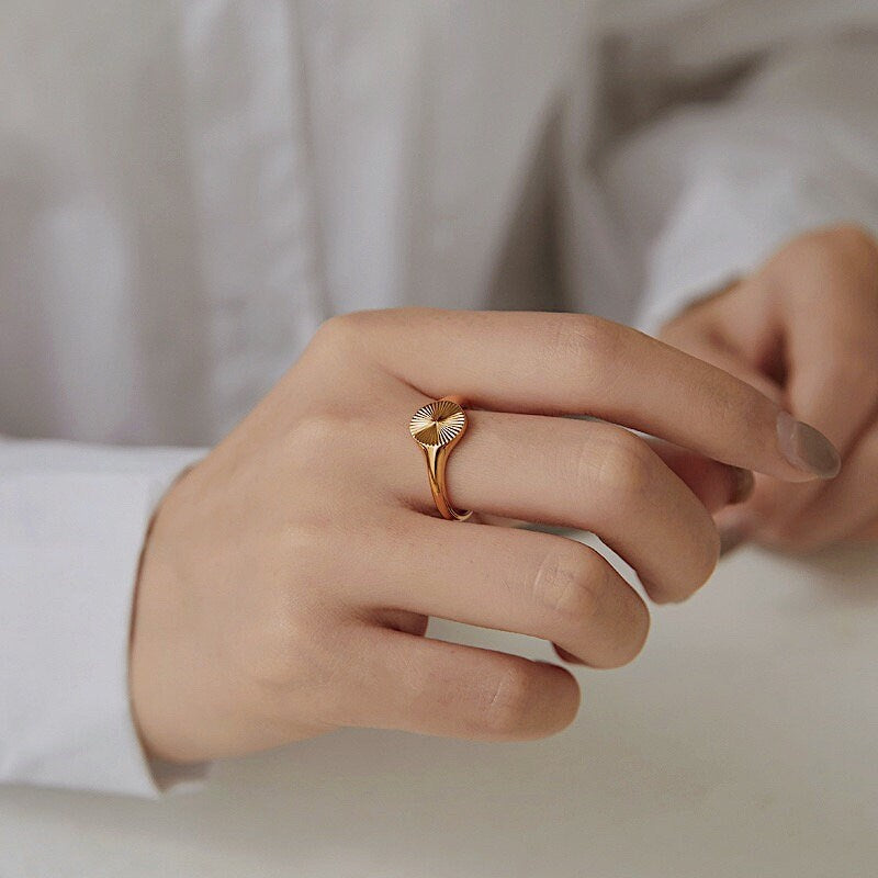Lifestyle shot of gold sun ring during cafe hoping