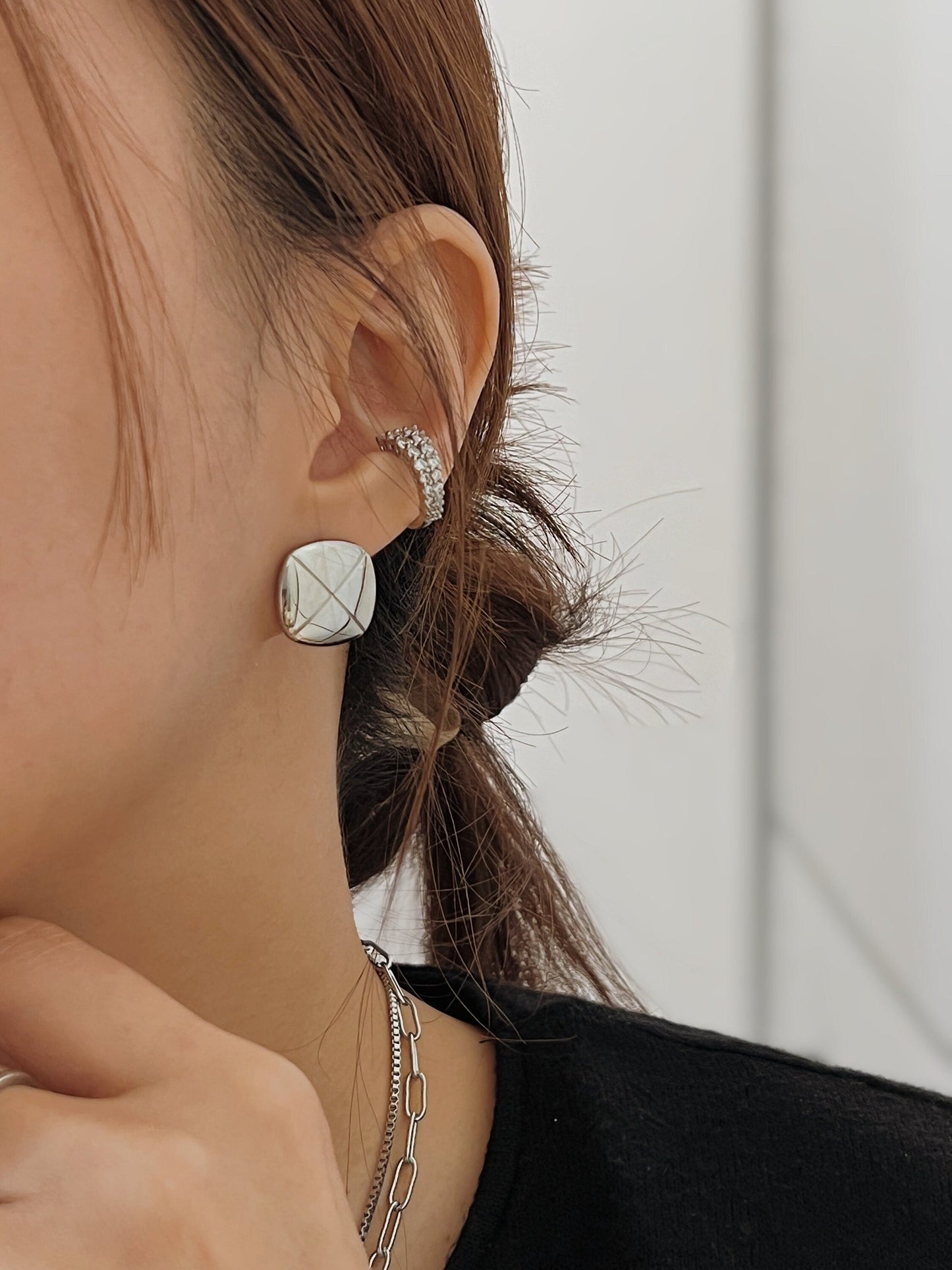 Model stacking Emily Cuffs together with a square studs for a maximalist ear party