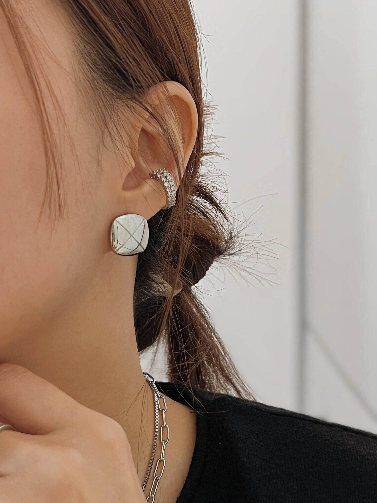 Model stacking Emily Cuffs together with a square studs for a maximalist ear party